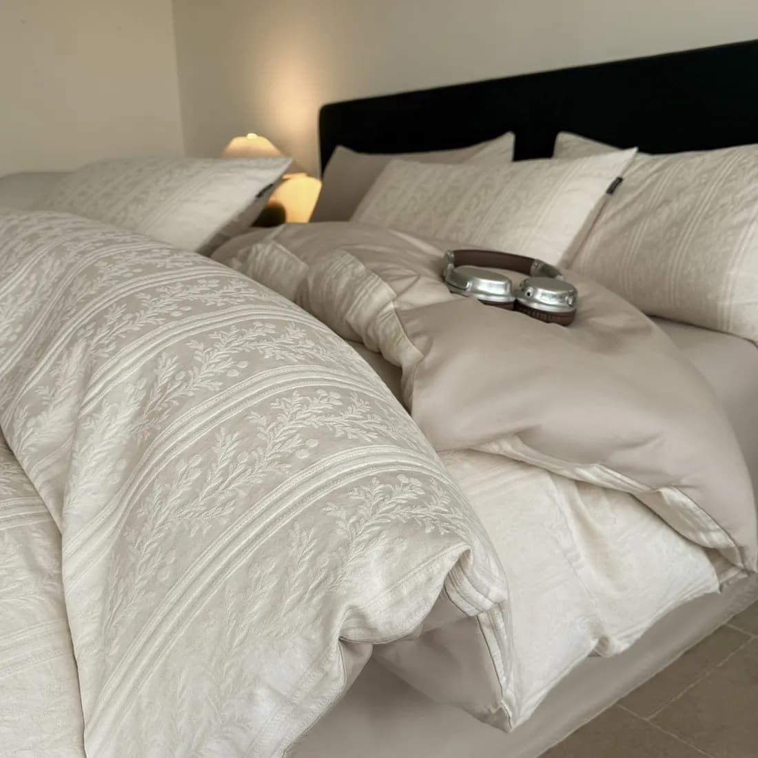 Close-up of combed-cotton sateen bedding showing fine single-ply yarn and even weave density