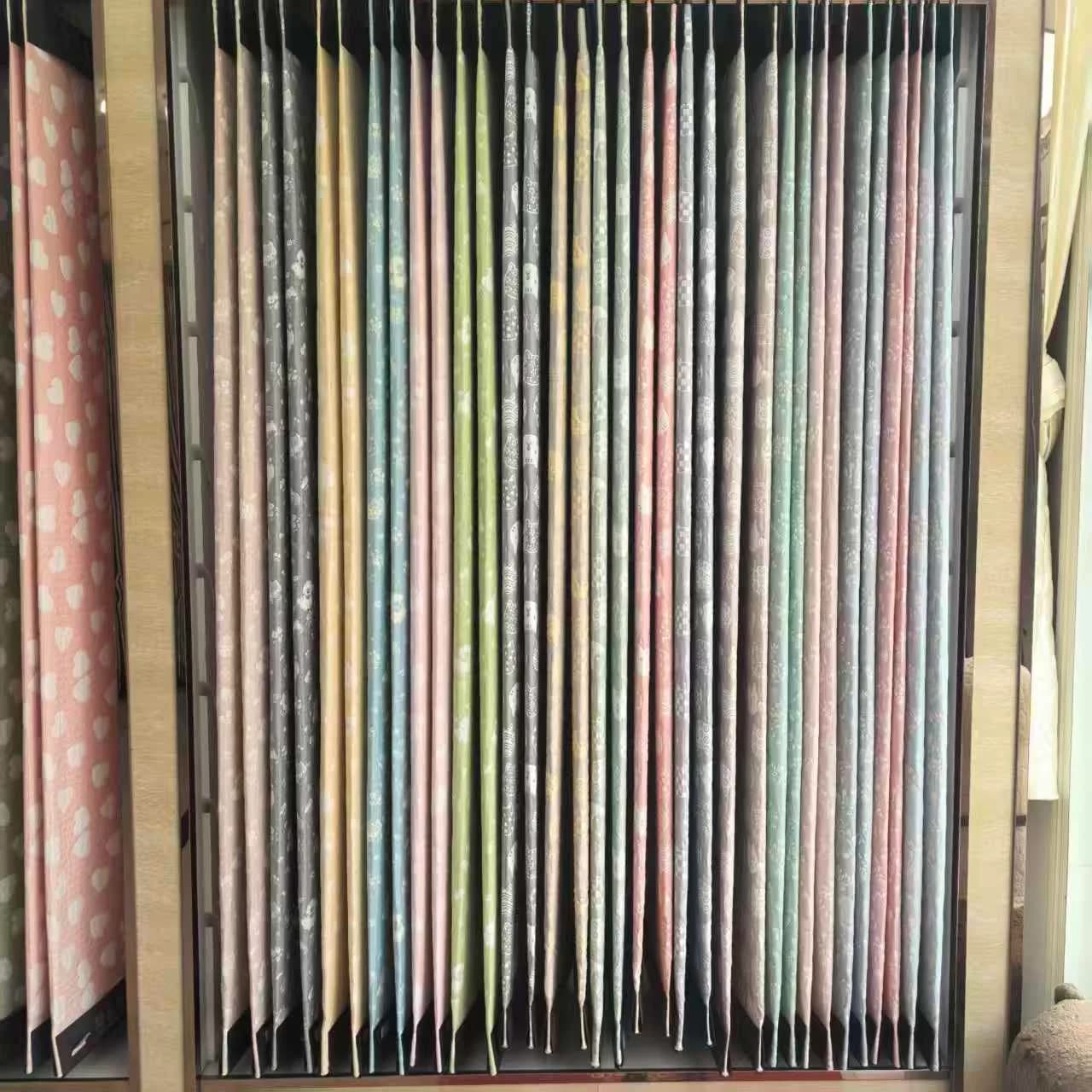 Printed cotton bedding swatches fanned out for specification and quality comparison against a quotation spec sheet
