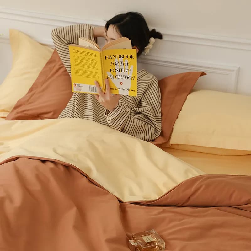 Two-tone yarn-dyed sateen bedding showing woven color contrast and deep dye penetration